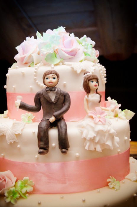 A close up picture of a wedding cake topper