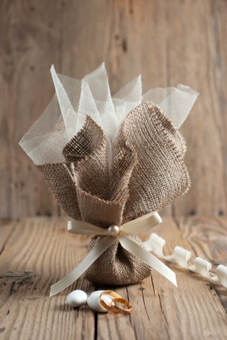 Burlap wedding favor on old wooden table