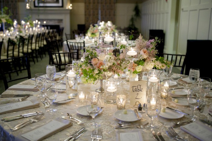 Elegant table setting for wedding reception with bouquets