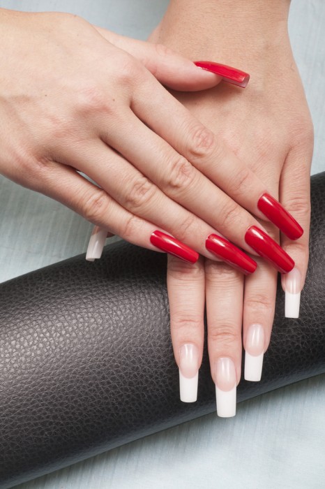 Hands with red manicure and french