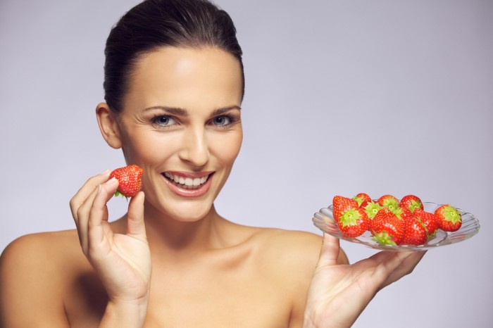 Woman with a plate of fresh strawberries