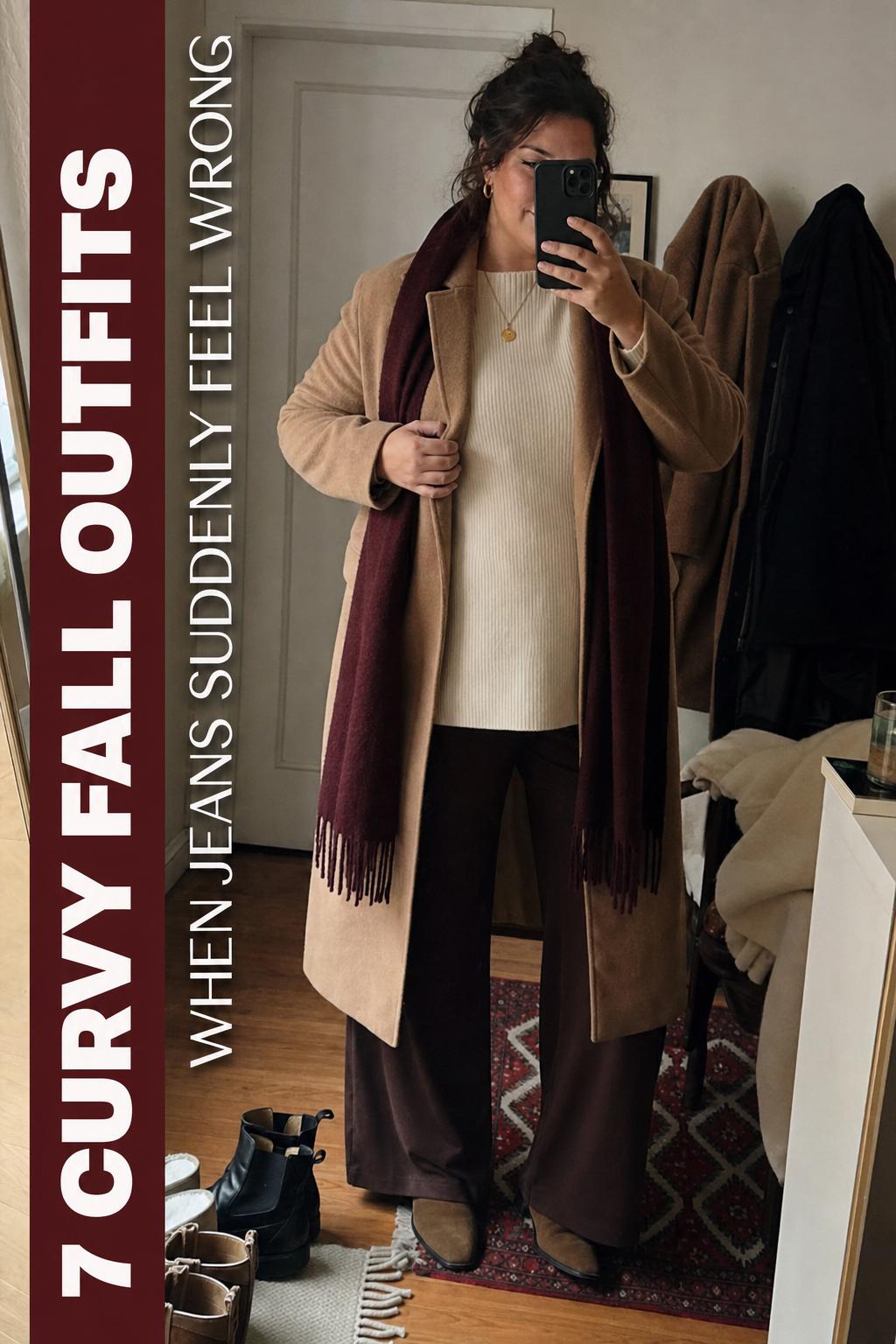 Curvy fall outfits mirror selfie featuring cream knit sweater, camel longline coat, wide-leg pants and ankle boots in a cozy apartment
