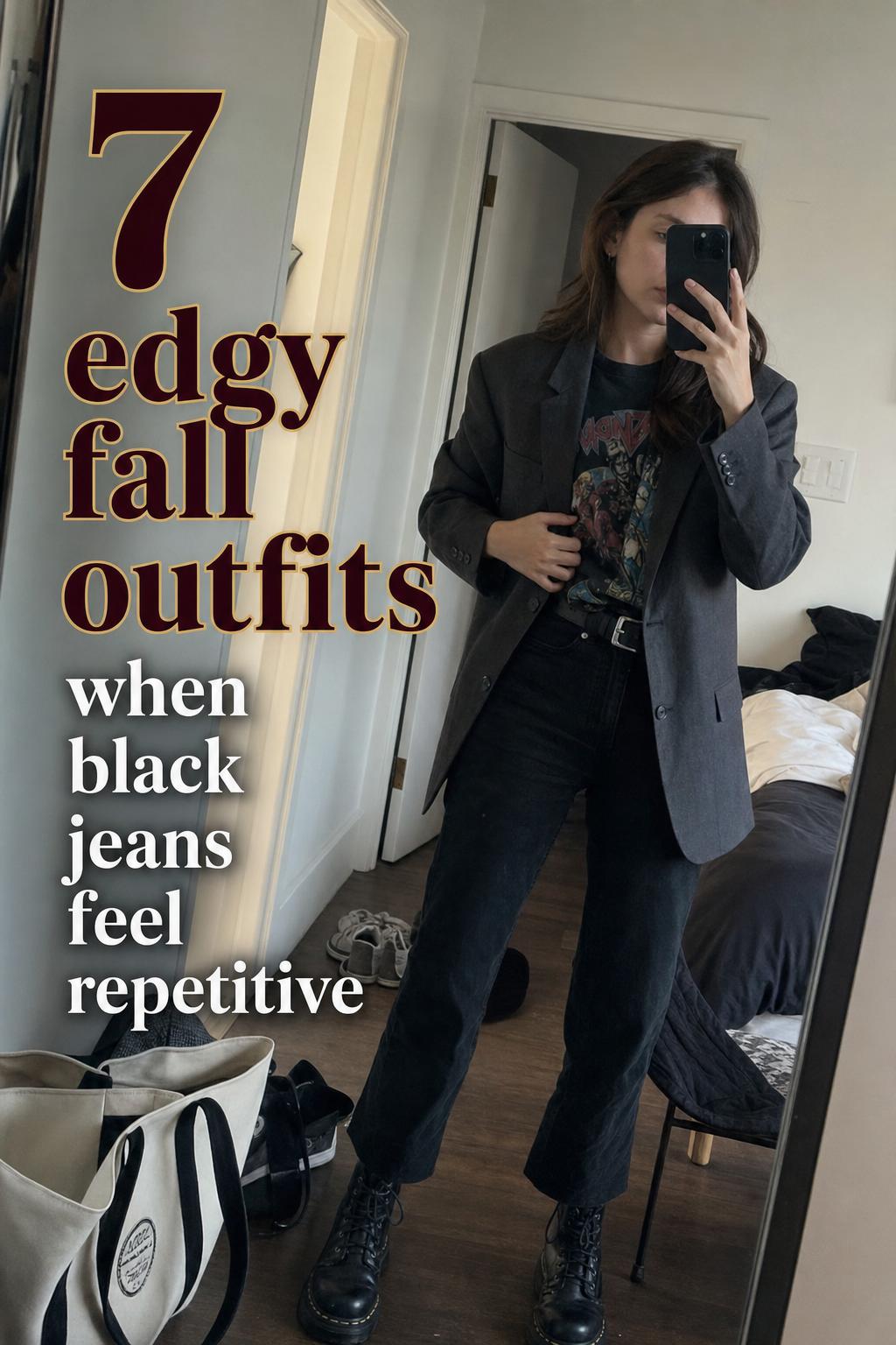 Mirror selfie of a woman in a charcoal blazer, graphic tee, black jeans and combat boots—edgy fall outfits in a messy apartment