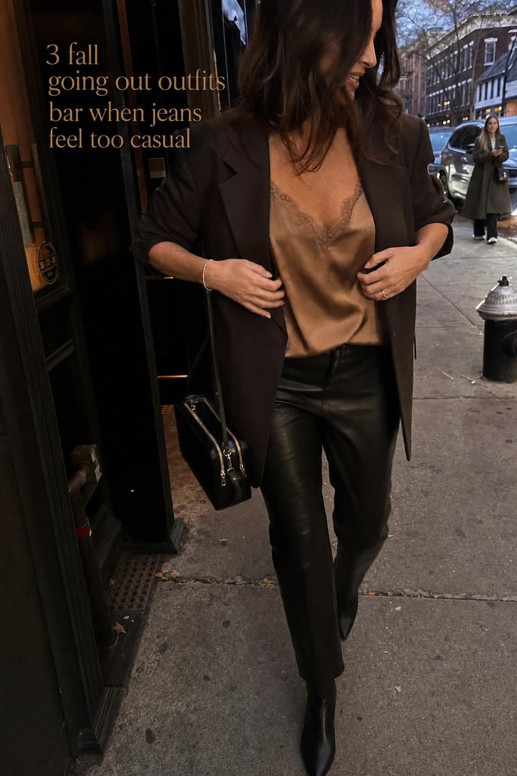 fall going out outfits bar look with woman adjusting blazer outside city lounge on a cool autumn evening