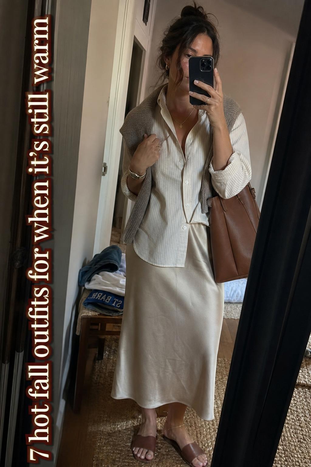 Hot fall outfits mirror selfie in warm weather with button-down, satin midi skirt, loafers, and structured bag in a lived-in hallway