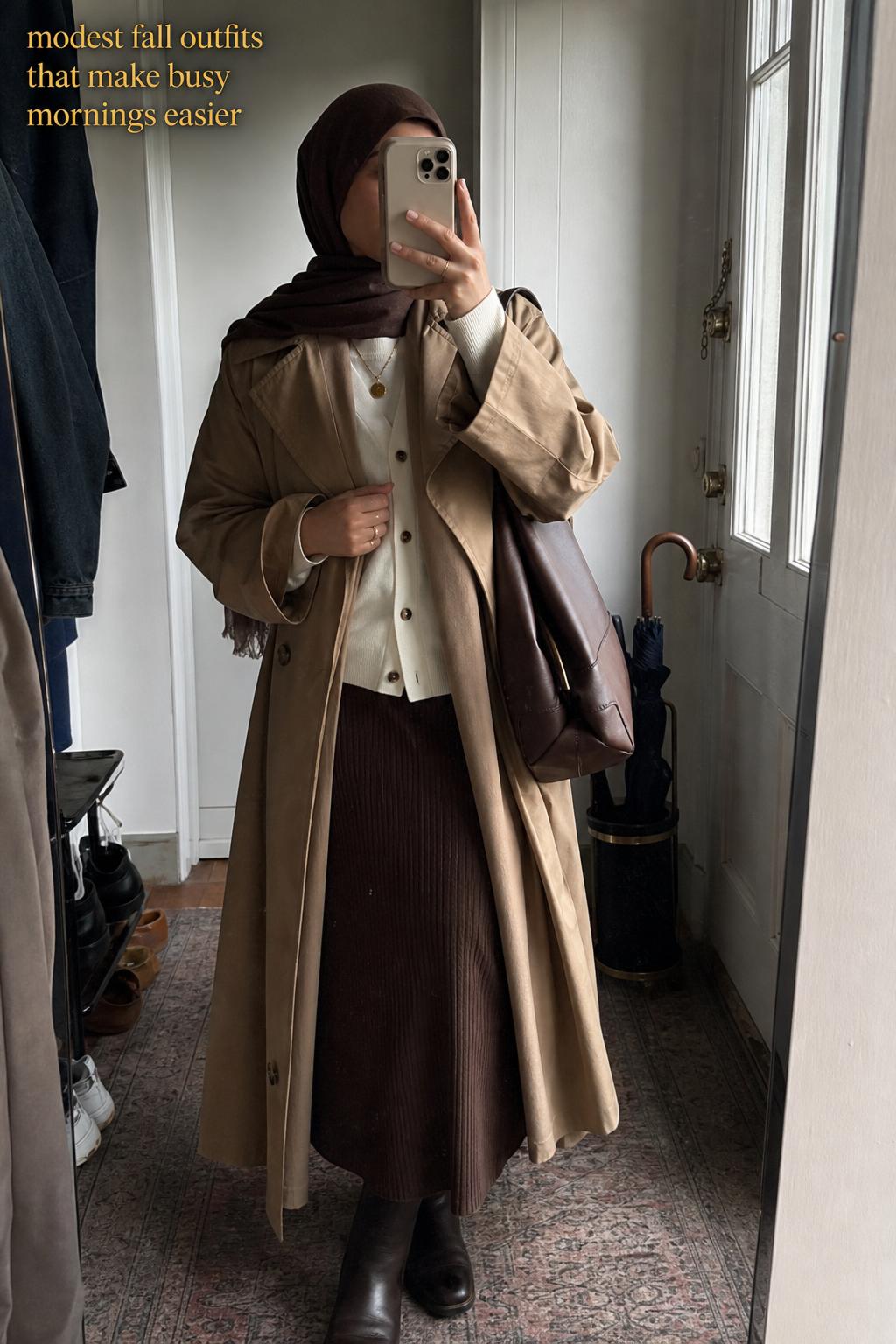 Woman in hallway mirror selfie wearing layered knit dress and blazer, showcasing modest fall outfits in neutral tones
