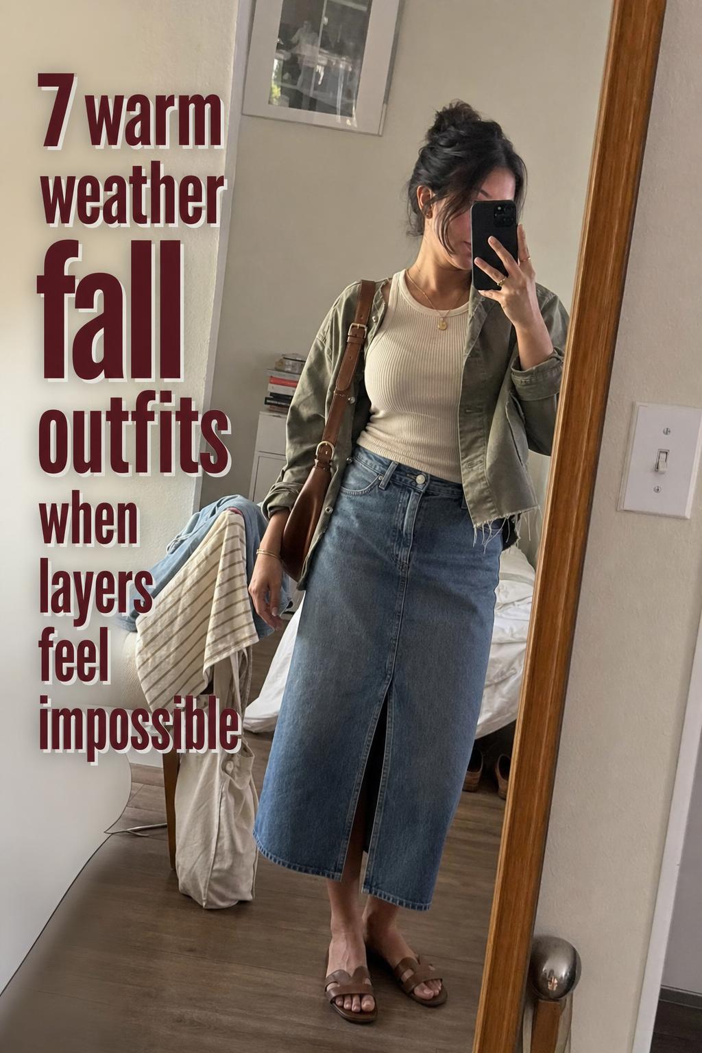 Mirror selfie of warm weather fall outfits with cream tank, denim, olive jacket and loafers in a casual apartment hallway