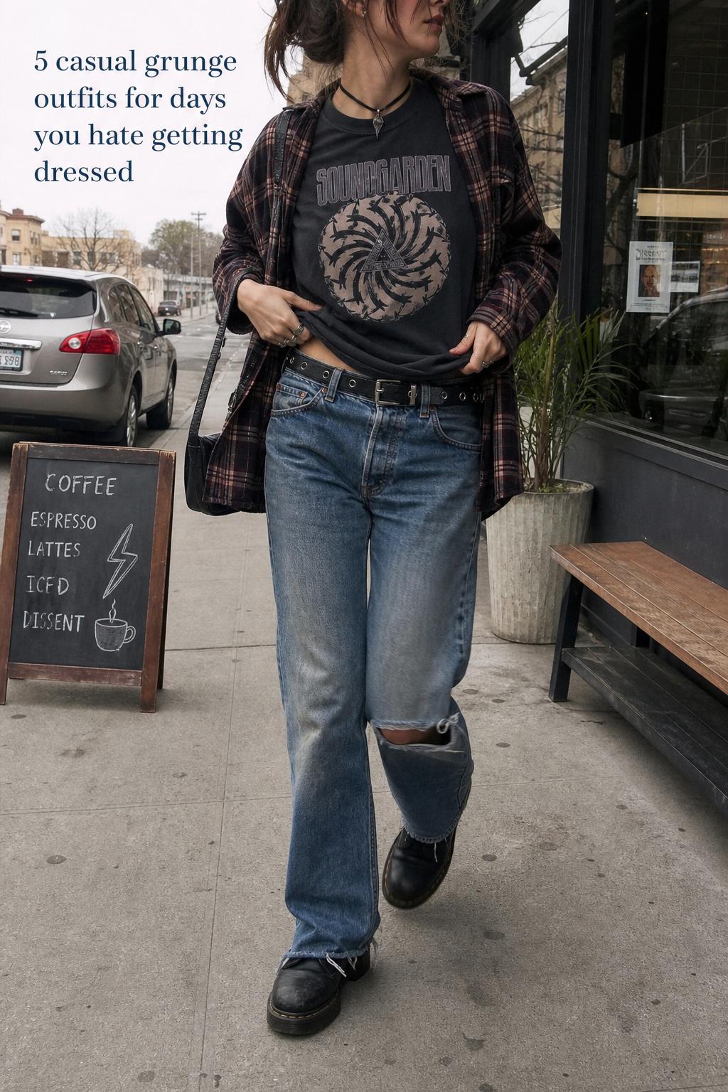 Casual grunge outfits street style with flannel, band tee, distressed jeans and boots walking past a coffee shop