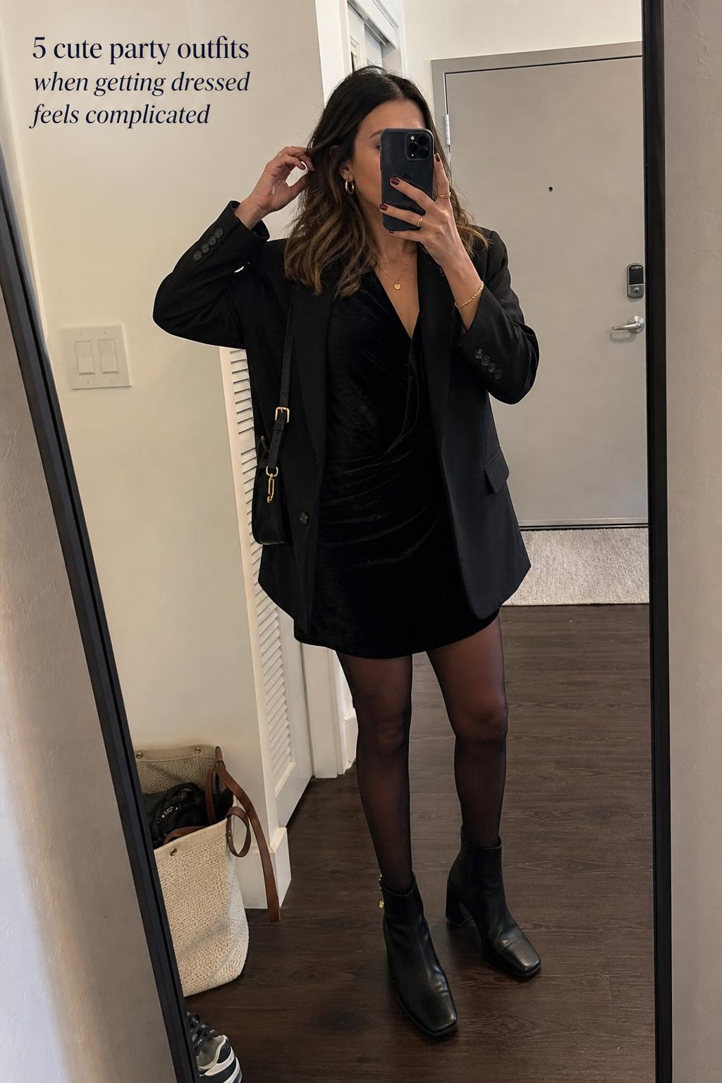 Cute party outfits mirror selfie in an apartment hallway, adult woman in velvet dress, blazer, tights and ankle boots