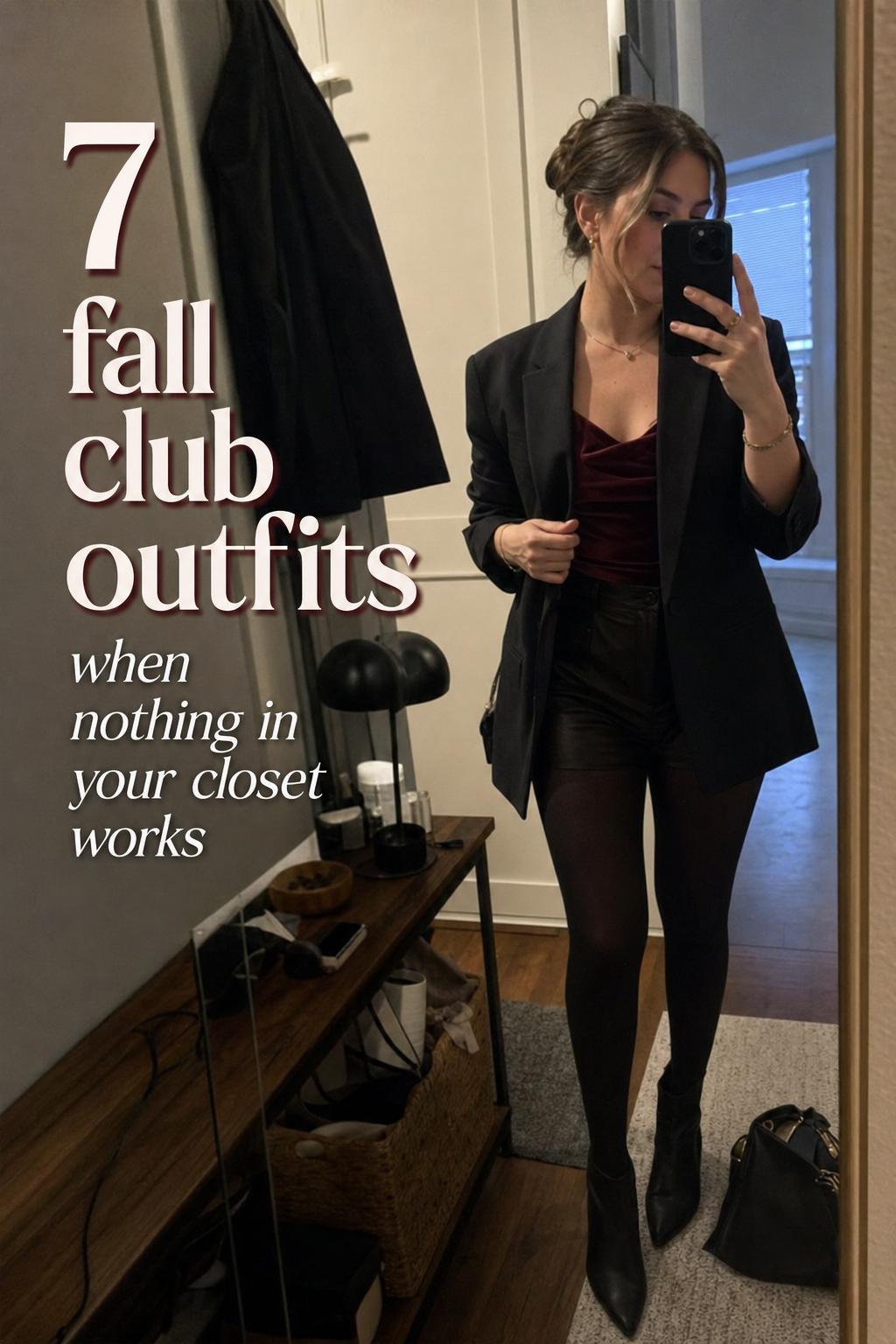 Mirror selfie of woman in black blazer and faux leather pants with text overlay about fall club outfits in a cozy apartment hallway