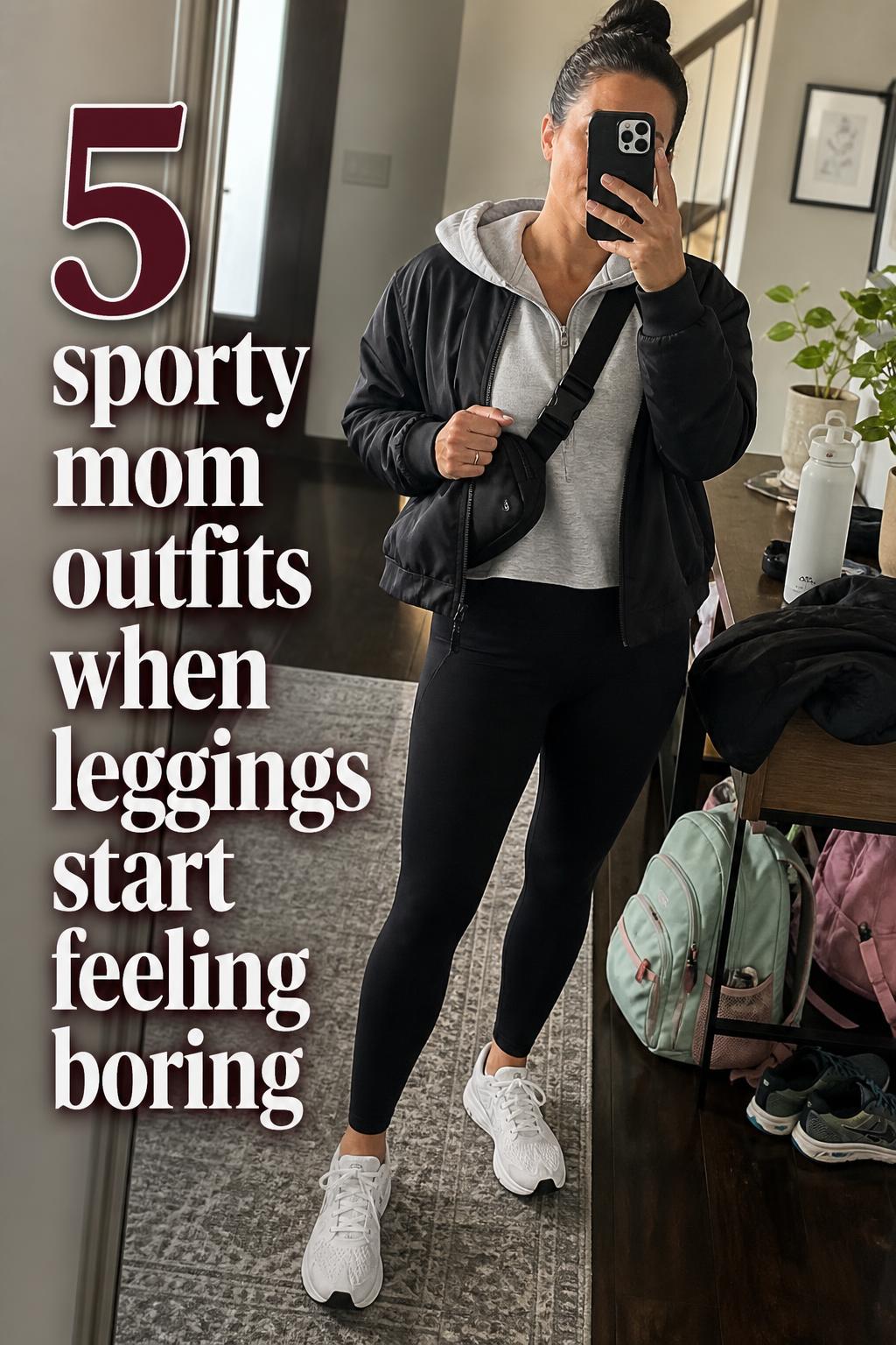 Sporty mom outfits mirror selfie in a suburban entryway, woman in black leggings, gray hoodie, white sneakers and crossbody bag