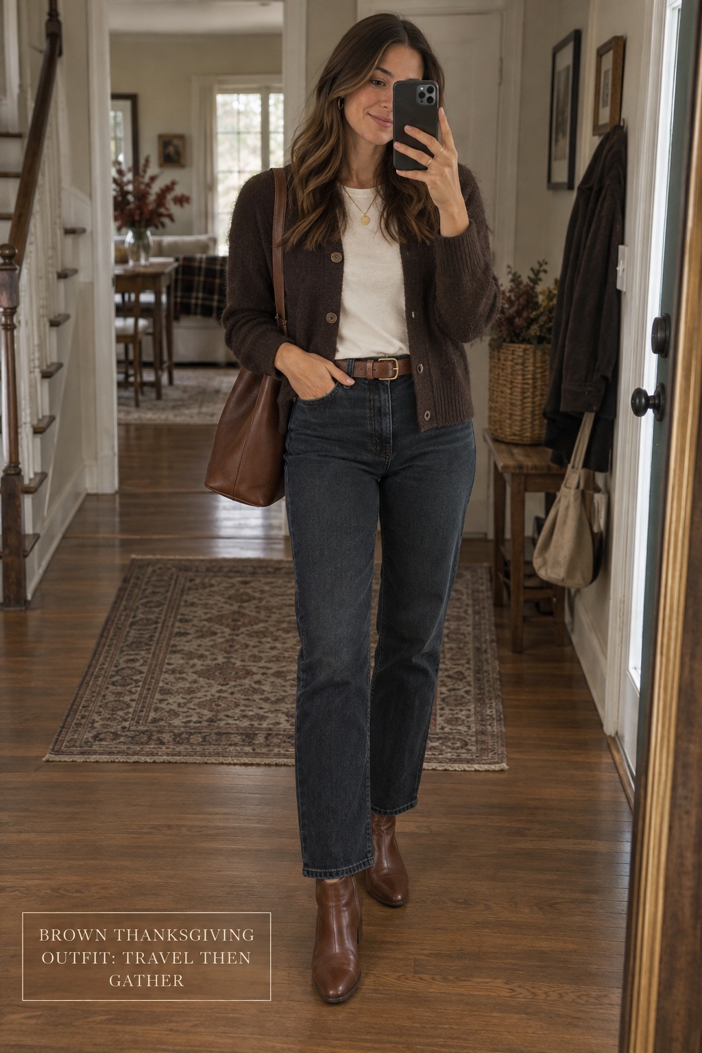 brown thanksgiving outfit mirror selfie with cardigan, dark jeans, and boots