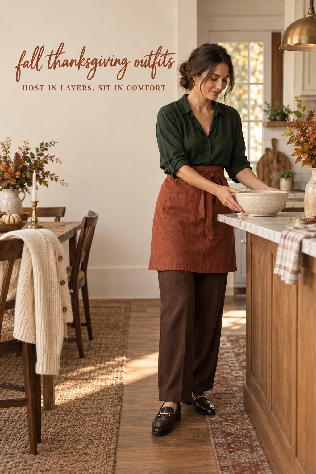 Fall Thanksgiving outfits host look with green blouse, rust apron, trousers, and loafers